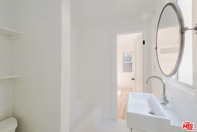 a bathroom with a sink and a mirror