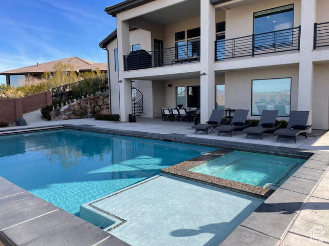 6026 Zen Trail Way St. George, UT 84790 - Photo 36 of 41 View of swimming pool featuring a patio, a pool with connected hot tub, and outdoor dining area