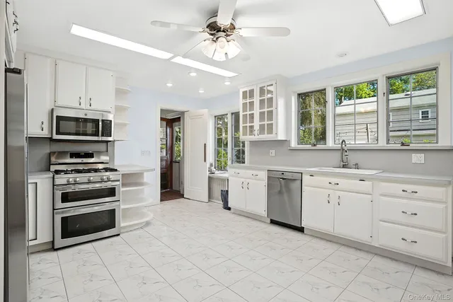 a kitchen with stainless steel appliances a stove sink and cabinets