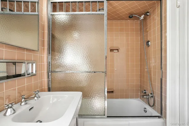 a bathroom with a tub and shower