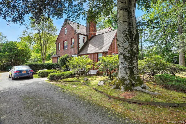 a couple of cars parked in front of a house