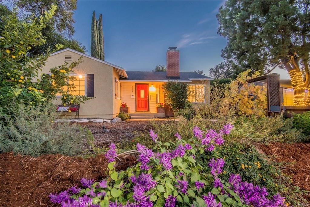 a view of a house with a yard and garden