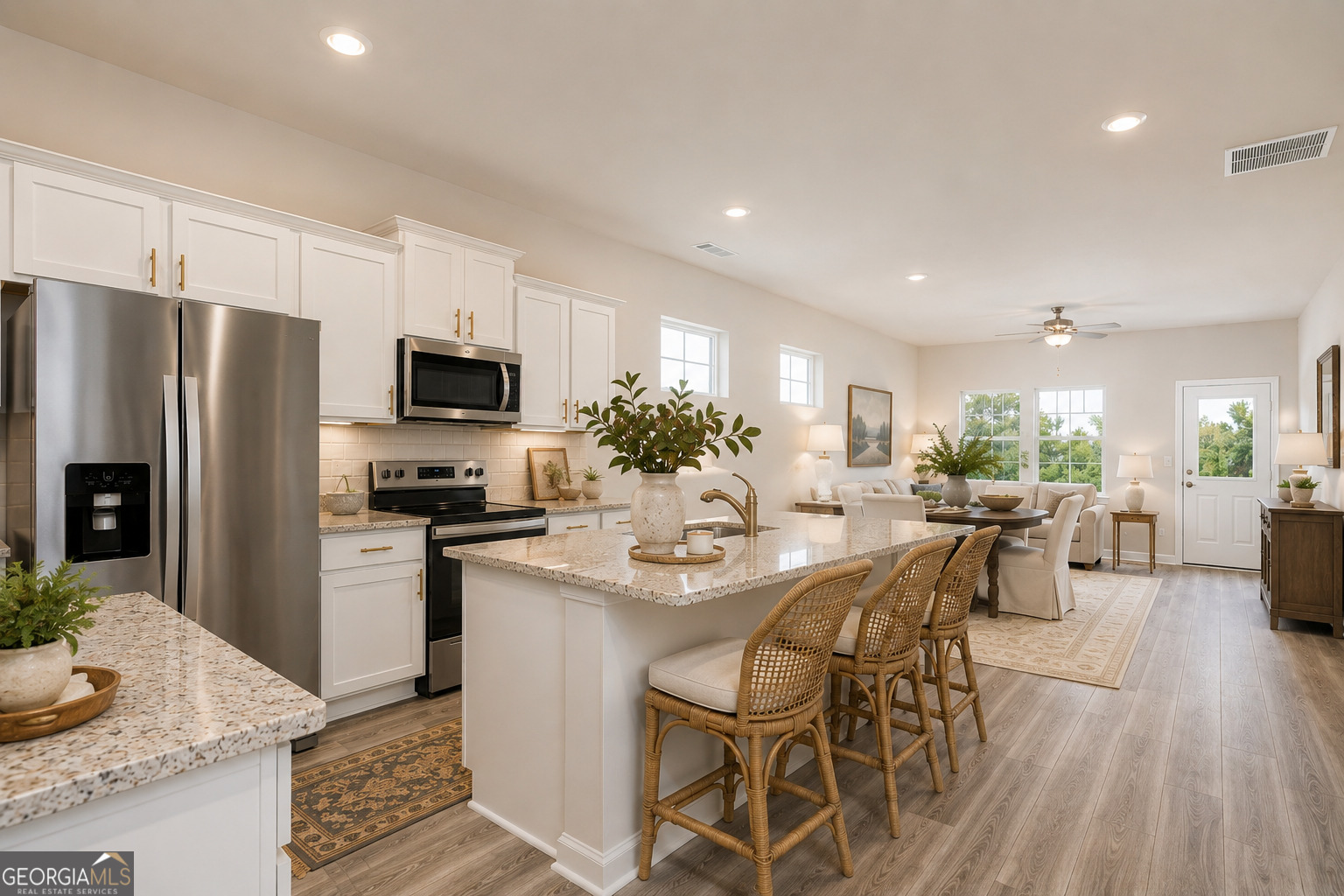 374 Slate Road Conyers, GA 30013 - Photo 6 of 8 a kitchen with stainless steel appliances kitchen island granite countertop a dining table and chairs