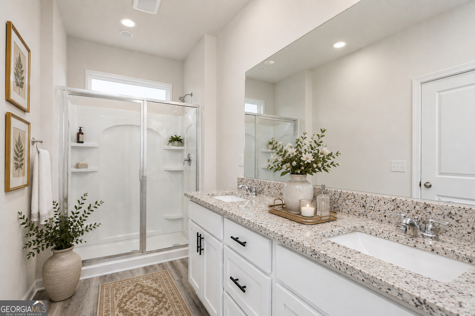 374 Slate Road Conyers, GA 30013 - Photo 7 of 8 a bathroom with a granite countertop sink a mirror and a shower