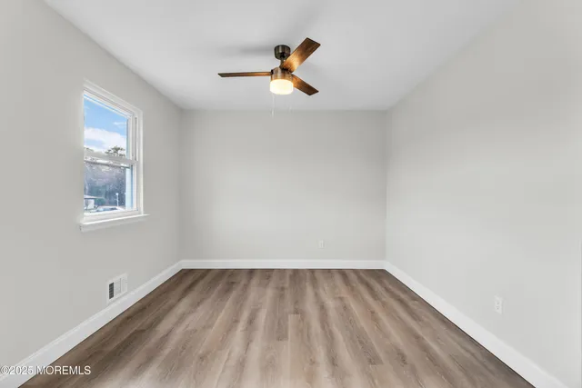 a view of room with window and ceiling fan