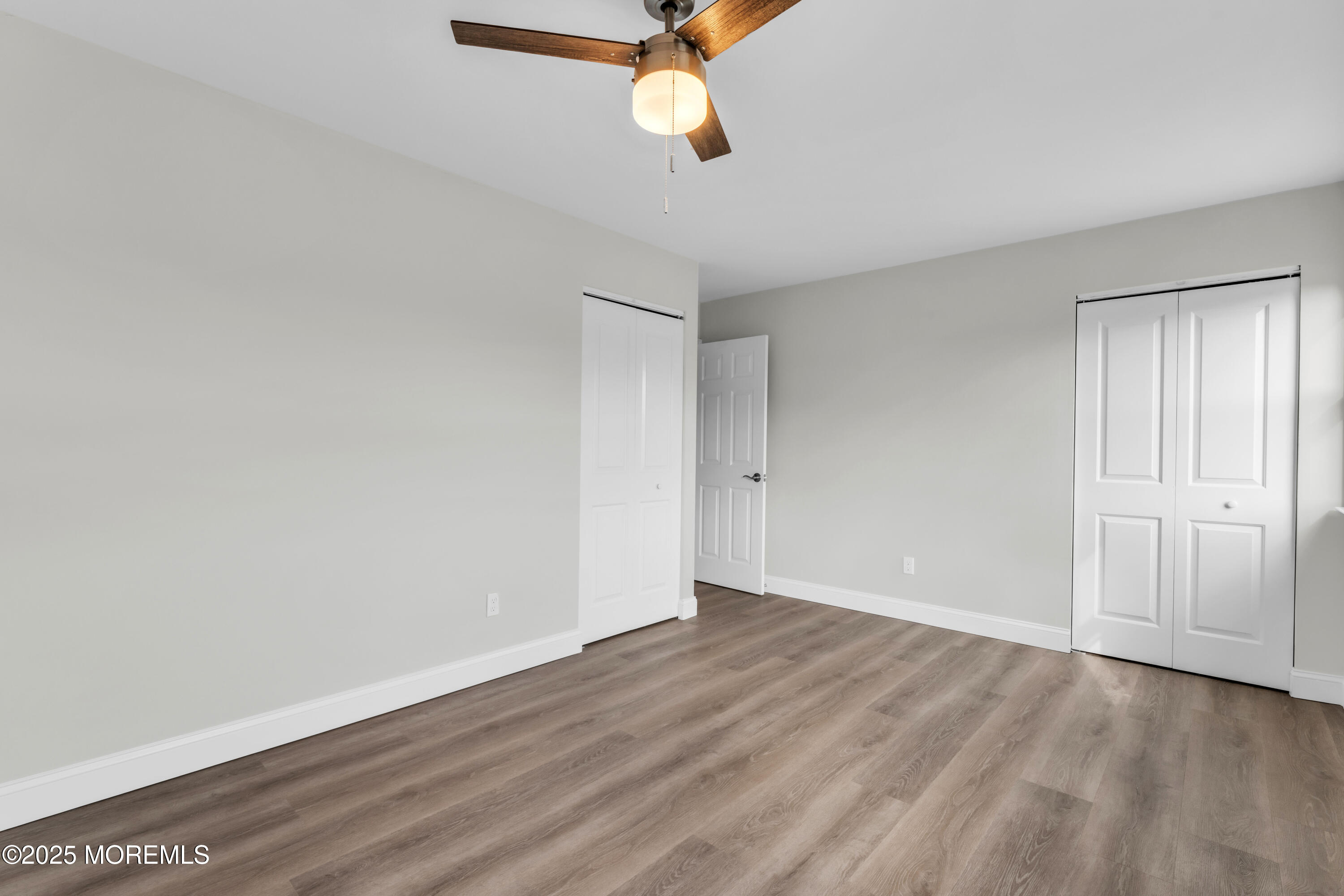 182 Greenwood Loop Road Brick, NJ 08724 - Photo 13 of 19 a view of an empty room with wooden floor and window