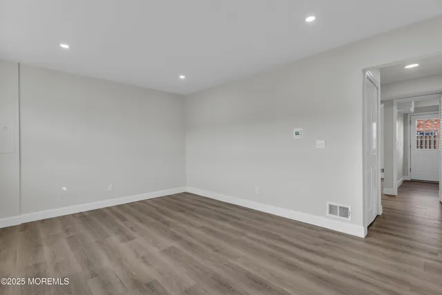 a view of a room with wooden floor