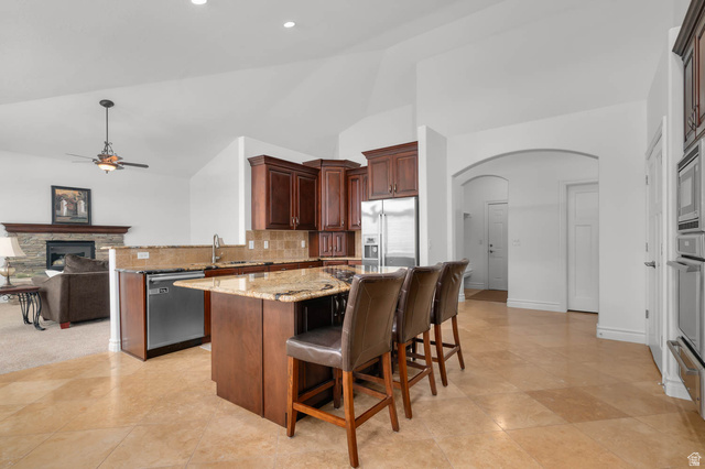 439 East 13540 South Draper, UT 84020 - Photo 11 of 46 Kitchen featuring a center island, granite countertops, wood cabinetry, and stainless steel appliances