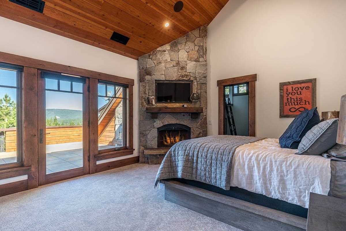 8207 Fallen Leaf Way Truckee, CA 96161 - Photo 20 of 21 a bed room with a bed and a fireplace