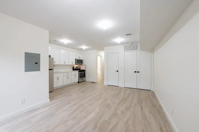 a view of a kitchen with wooden floor