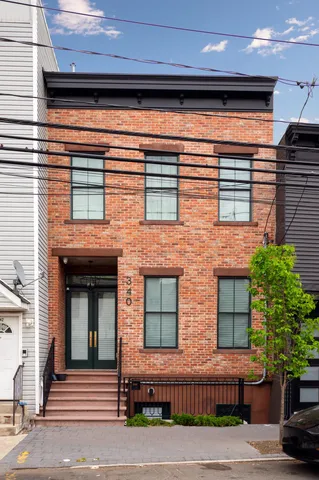 a view of a brick house with large windows