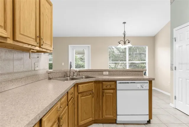 a kitchen with granite countertop a sink stove and cabinets
