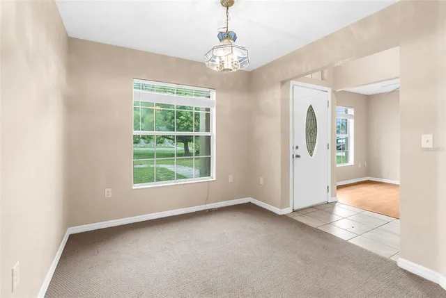 an empty room with windows and entrance