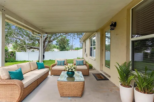 a balcony with furniture and a potted plant
