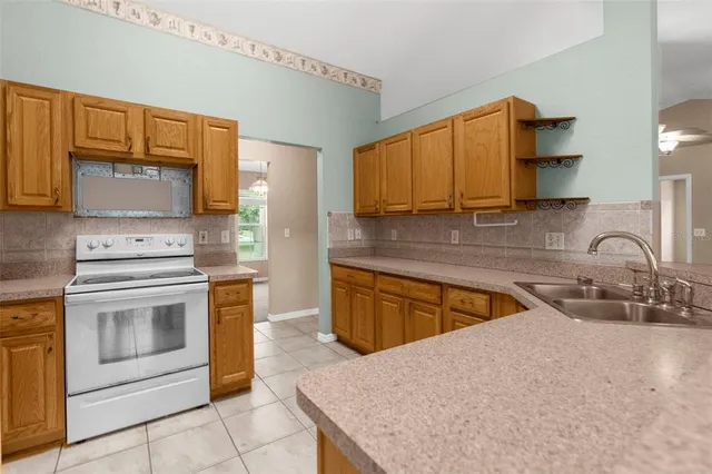 a kitchen with stainless steel appliances granite countertop a sink stove and microwave