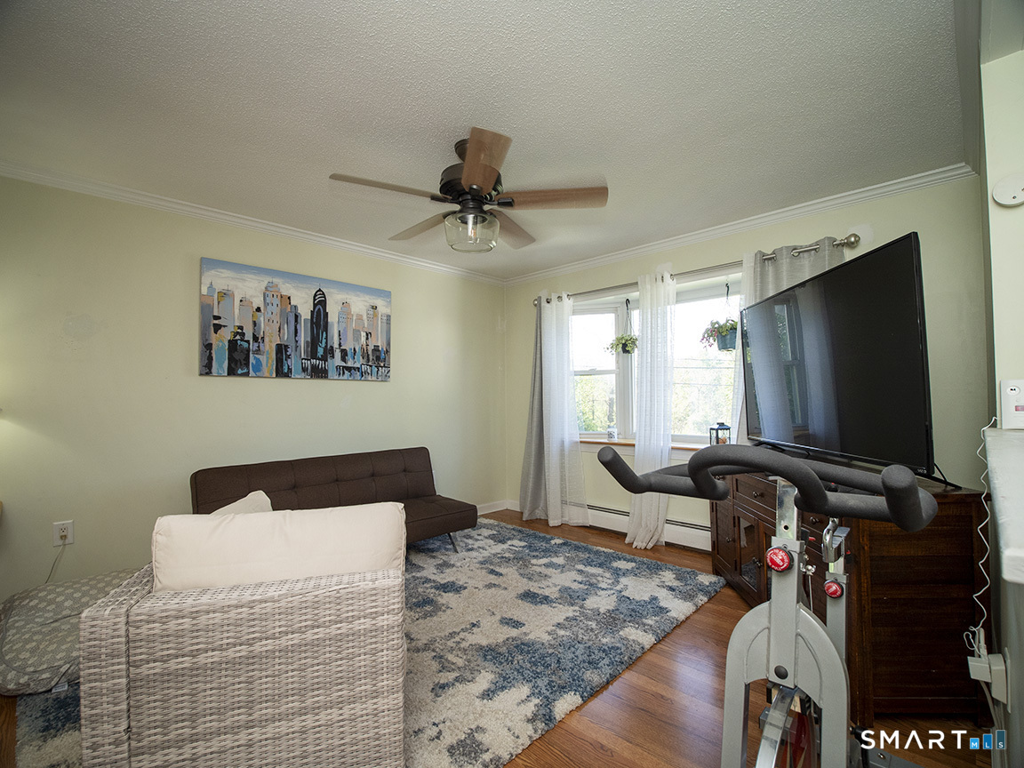 82 Wilcox Road Middletown, CT 06457 - Photo 9 of 27 a bedroom with a bed and a flat screen tv