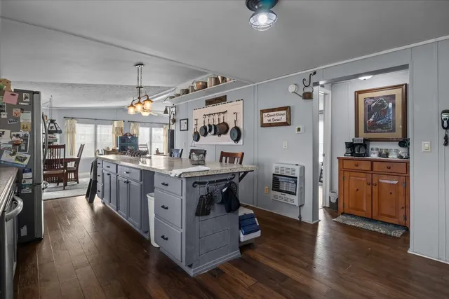 a bathroom with a granite countertop sink and a toilet
