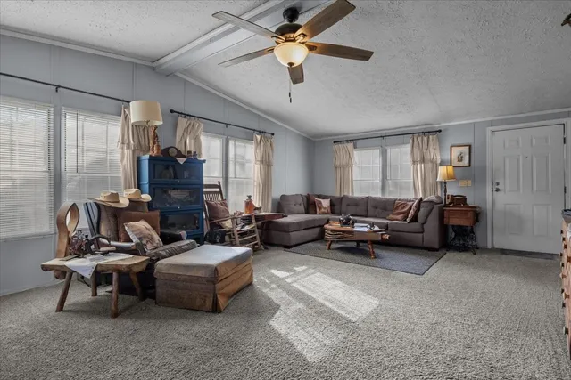 a kitchen with granite countertop a stove a sink dishwasher a dining table and chairs with wooden floor