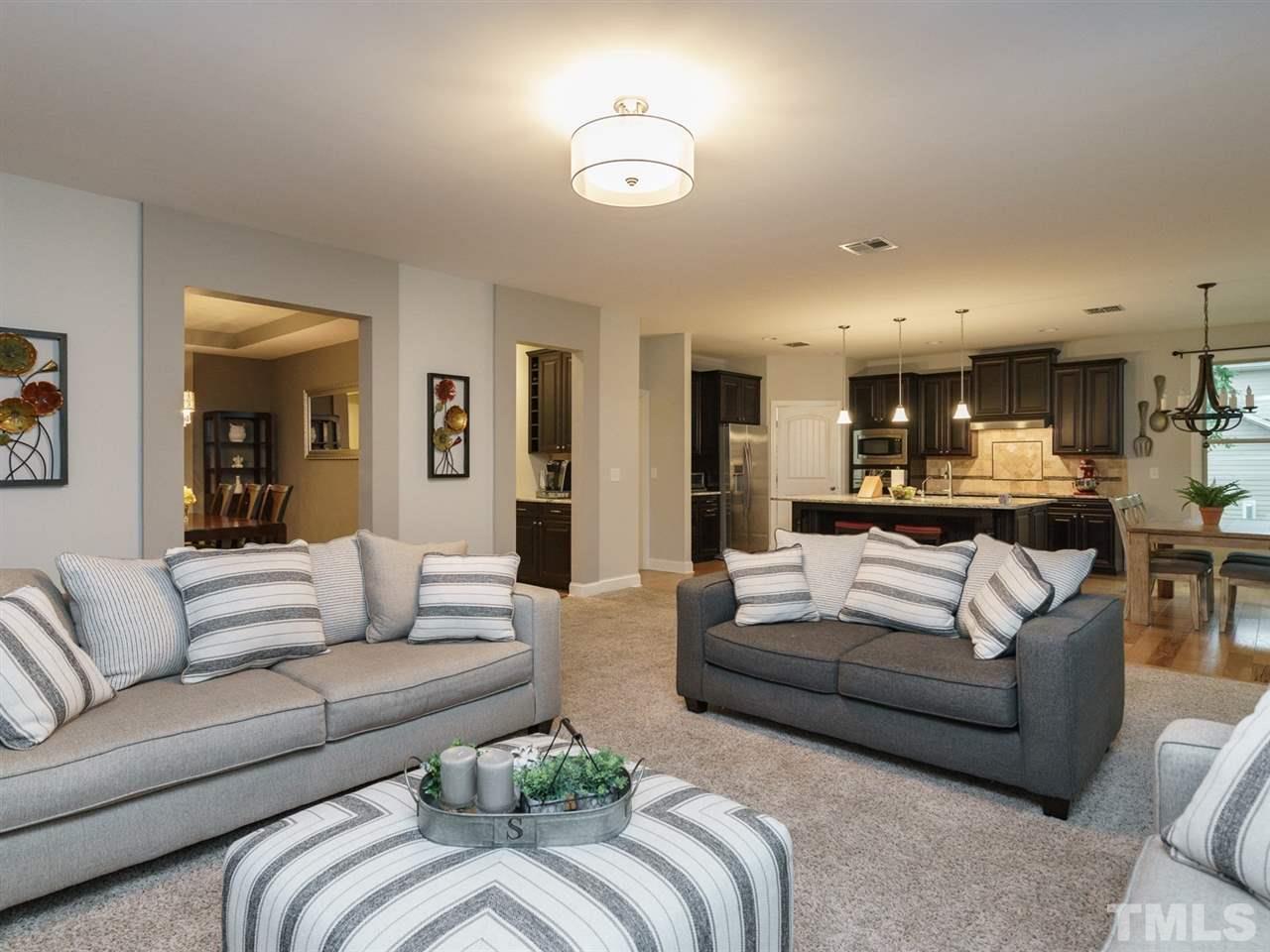 4844 Inwood Road Raleigh, NC 27603 - Photo 10 of 25 a living room with furniture and a view of kitchen