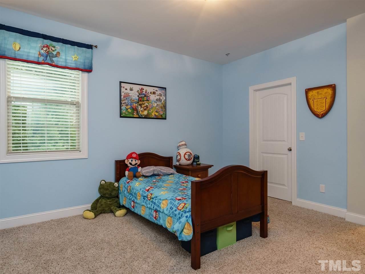 4844 Inwood Road Raleigh, NC 27603 - Photo 16 of 25 a bedroom with a bed and a window