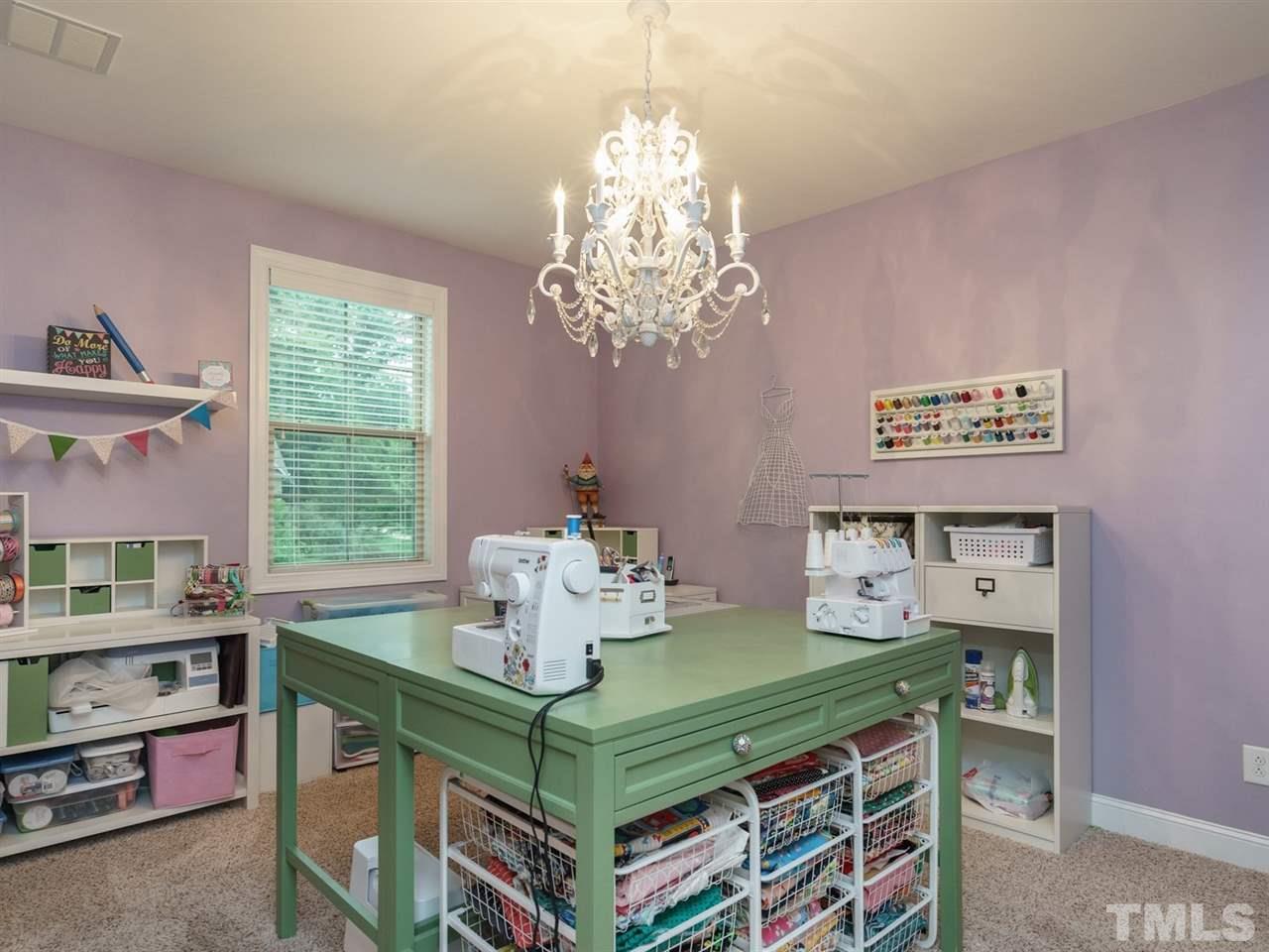 4844 Inwood Road Raleigh, NC 27603 - Photo 17 of 25 a room with a table chairs and a chandelier