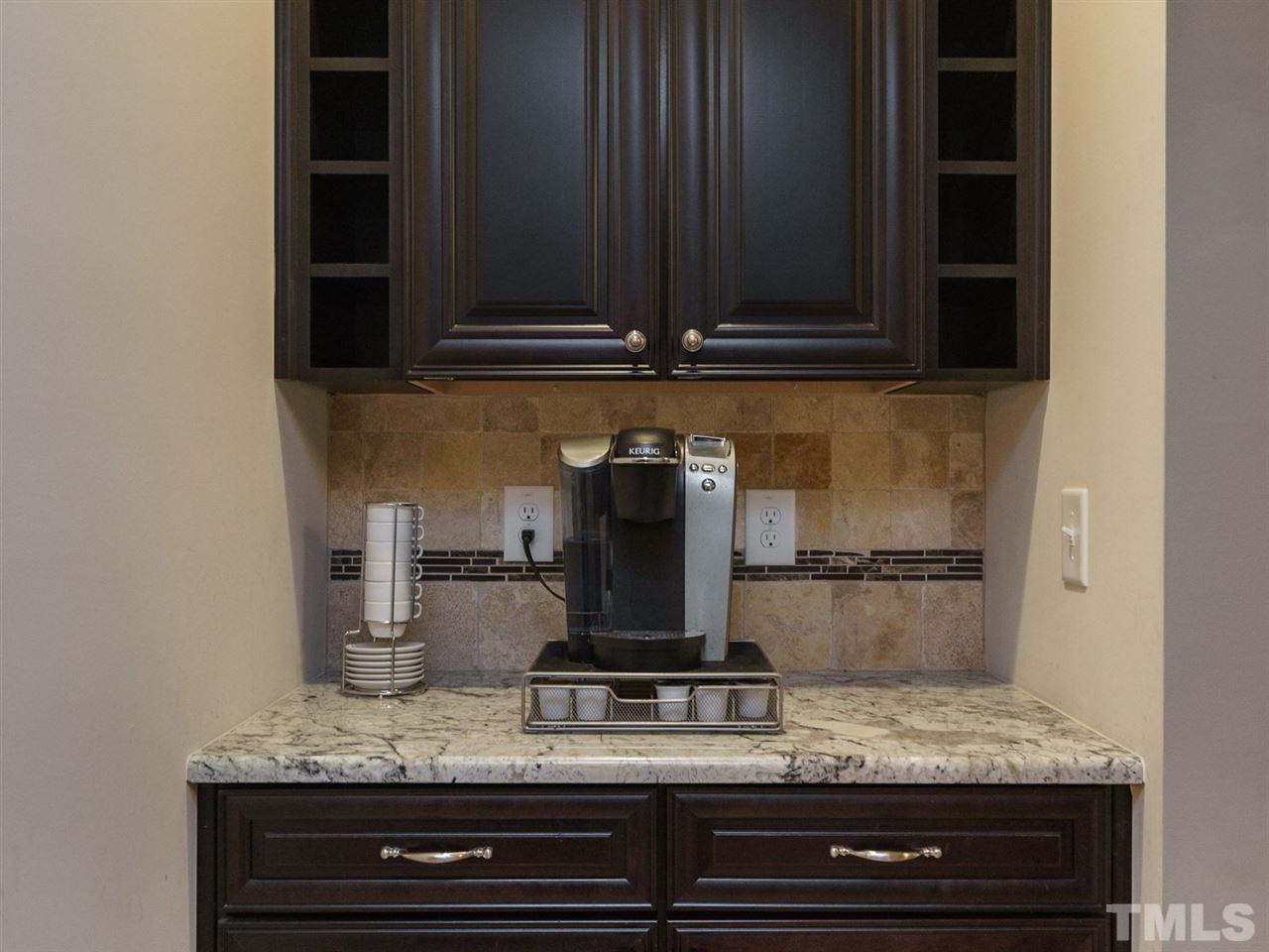 4844 Inwood Road Raleigh, NC 27603 - Photo 4 of 25 a kitchen with a stove and cabinets