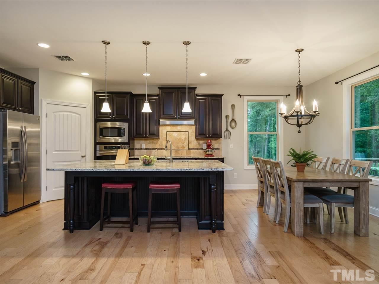 4844 Inwood Road Raleigh, NC 27603 - Photo 6 of 25 a large kitchen with a table and chairs
