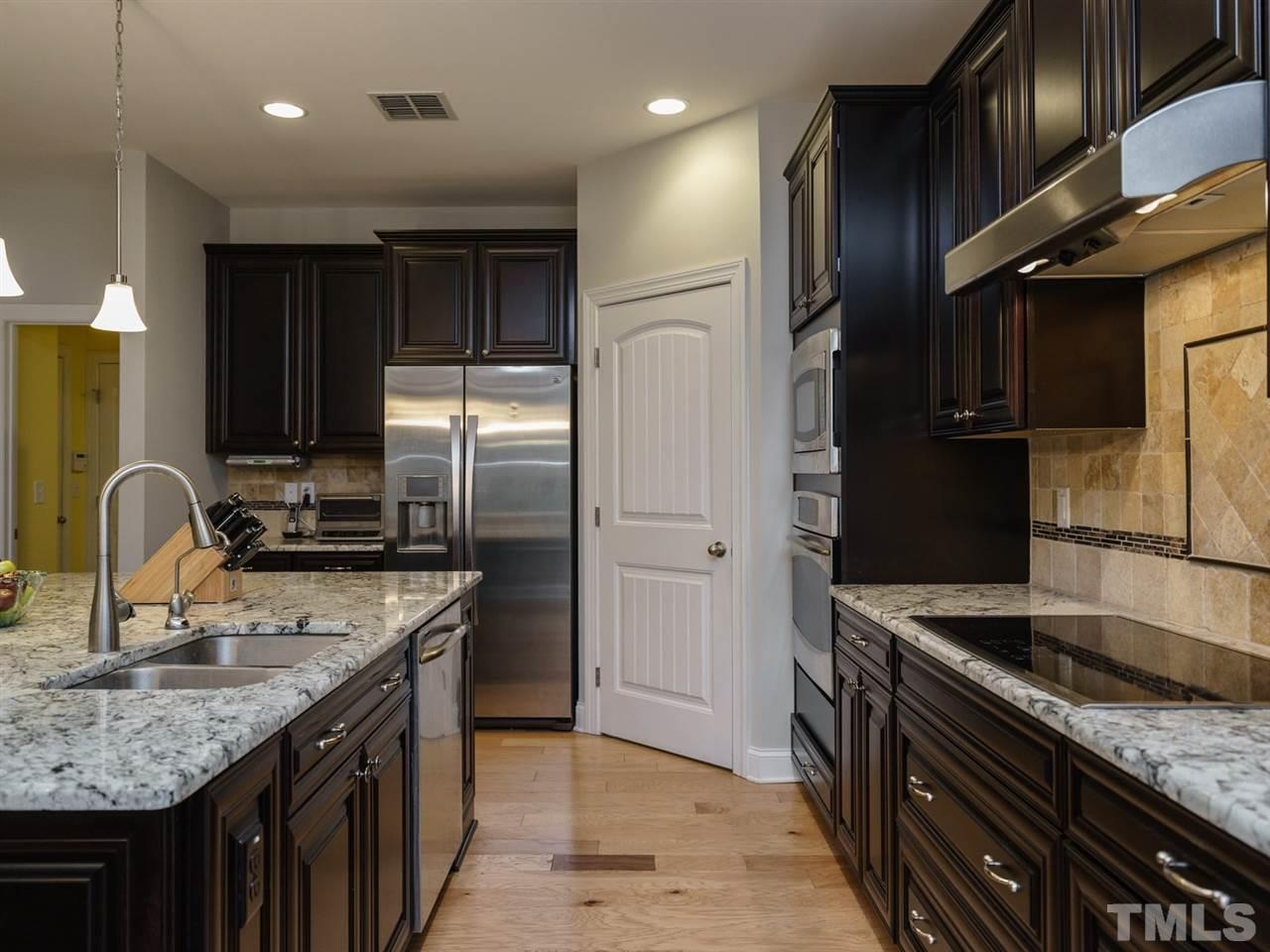 4844 Inwood Road Raleigh, NC 27603 - Photo 25 of 25 a kitchen with granite countertop a sink stainless steel appliances and cabinets