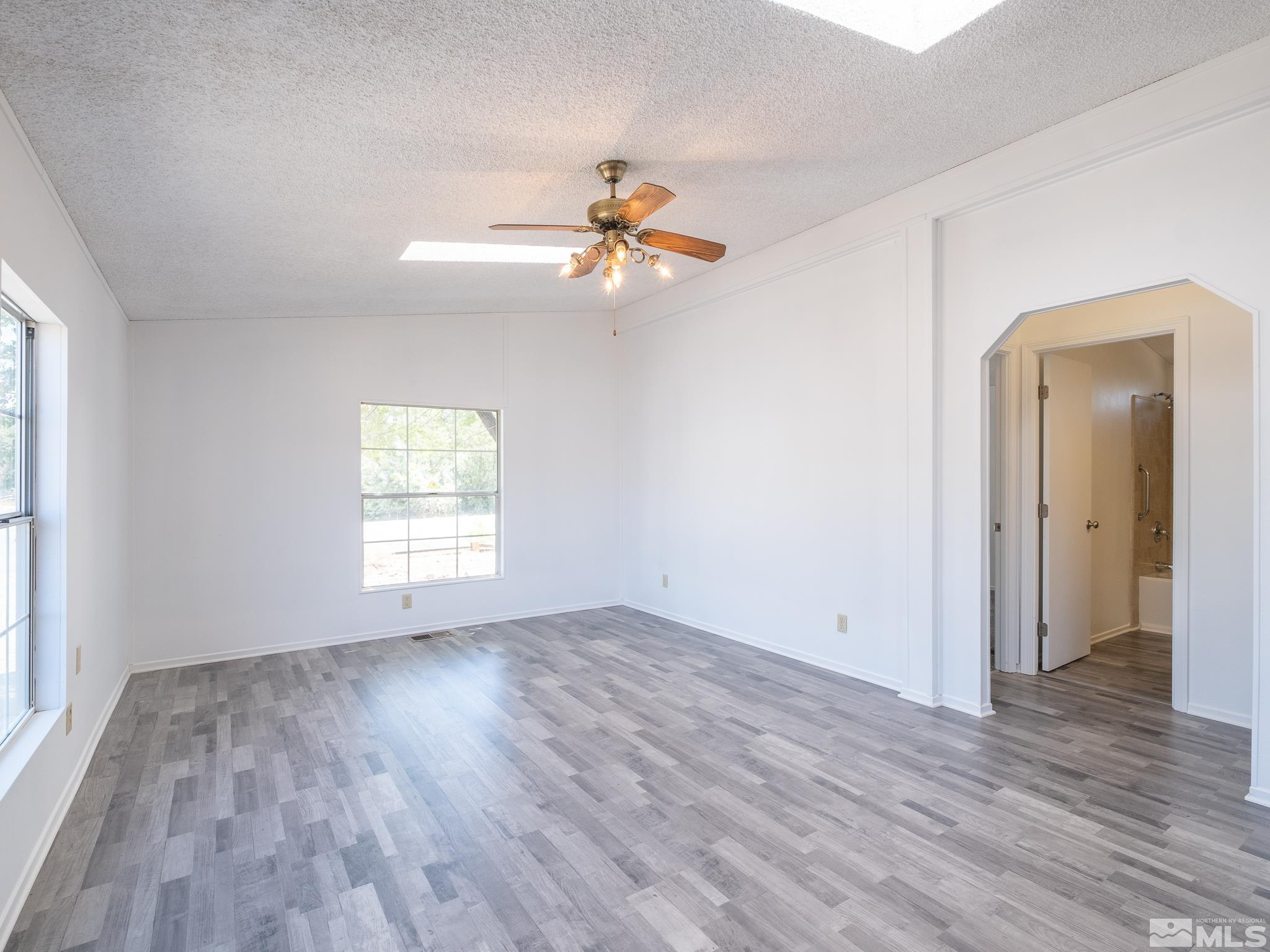 3975 Sandpiper Drive Reno, NV 89508 - Photo 17 of 35 an empty room with wooden floor ceiling fan and windows