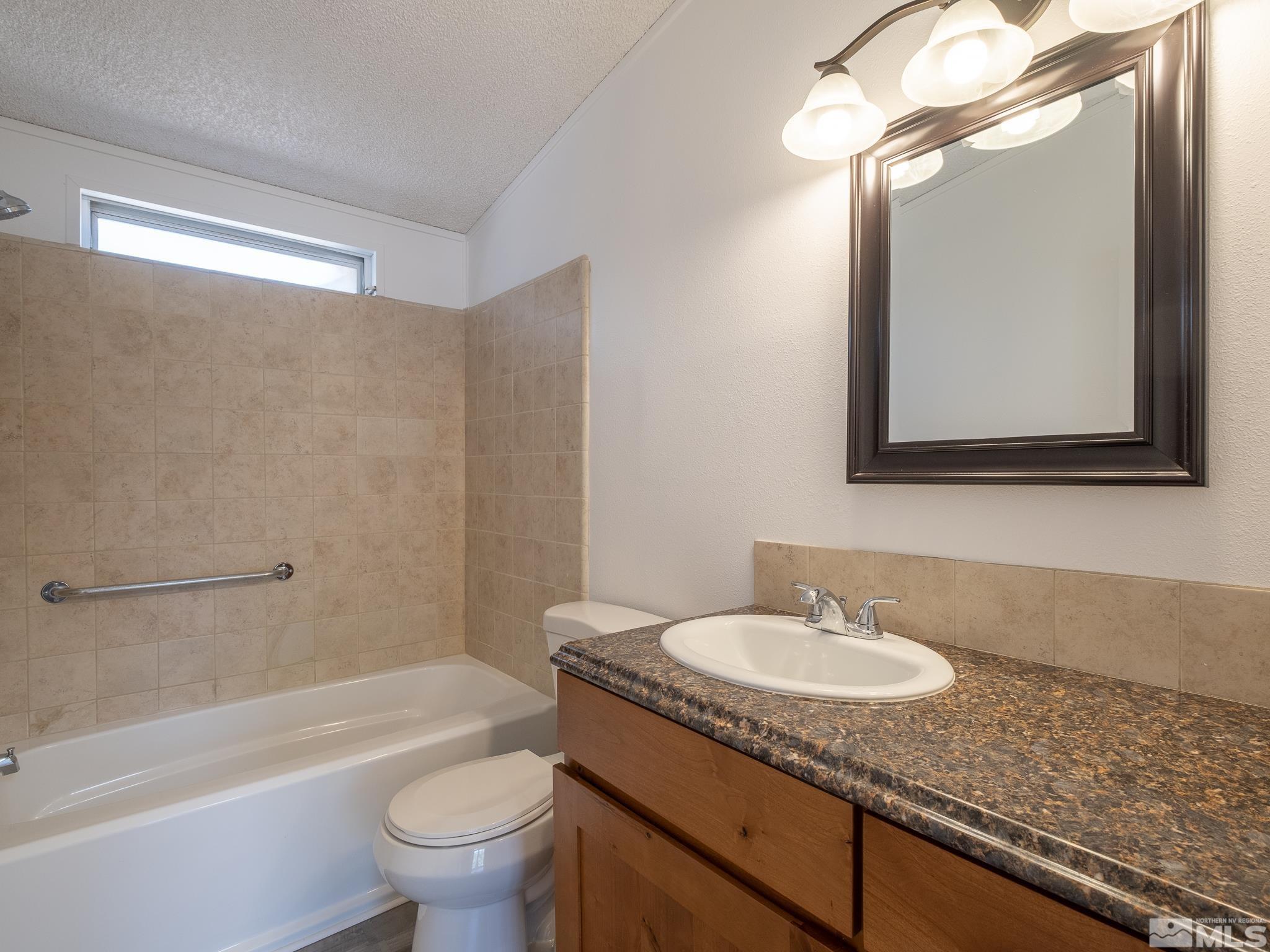 3975 Sandpiper Drive Reno, NV 89508 - Photo 27 of 35 a bathroom with a granite countertop sink toilet and shower