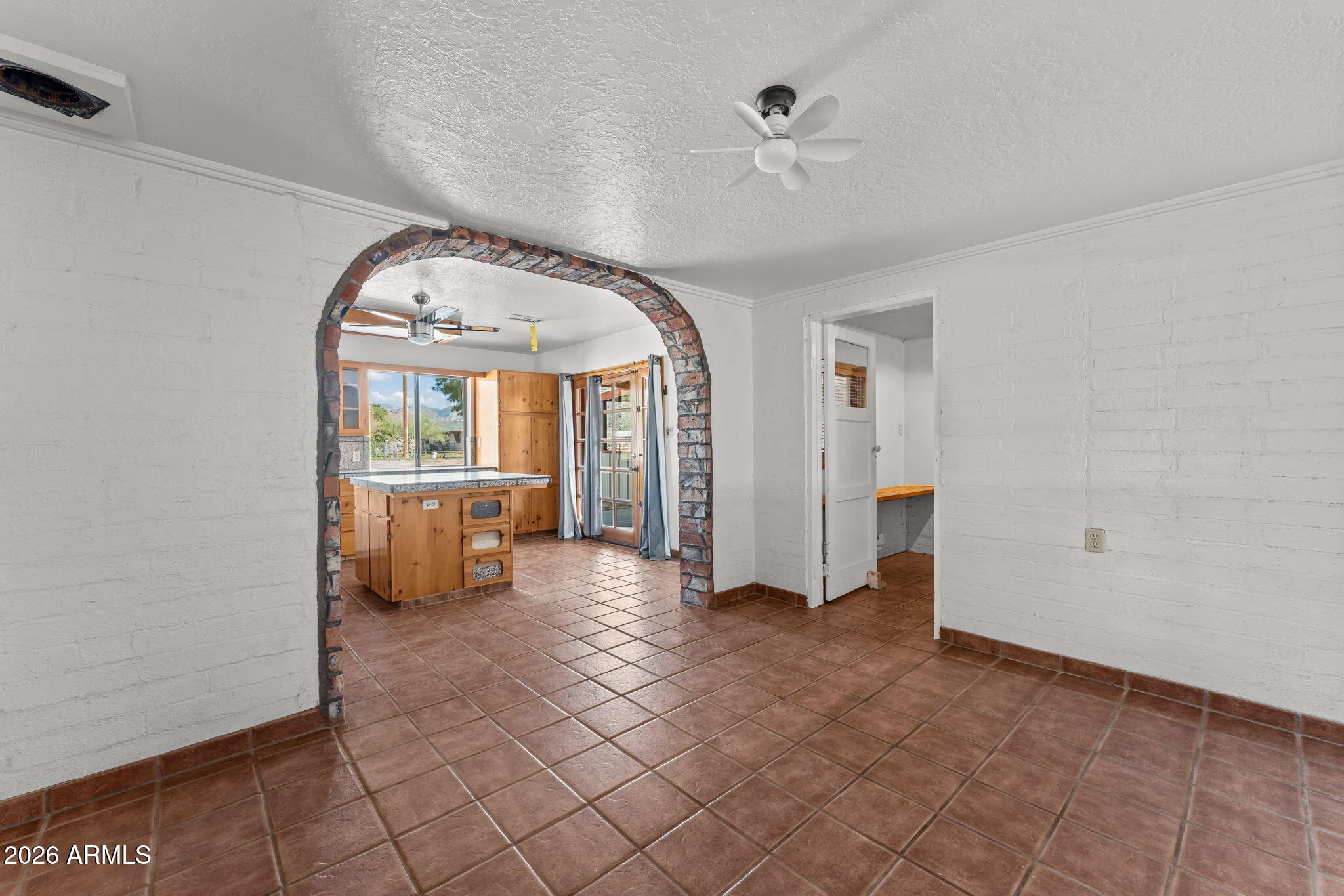 22905 Ranch Road Congress, AZ 85332 - Photo 15 of 26 a view of a livingroom with wooden floor and a kitchen space