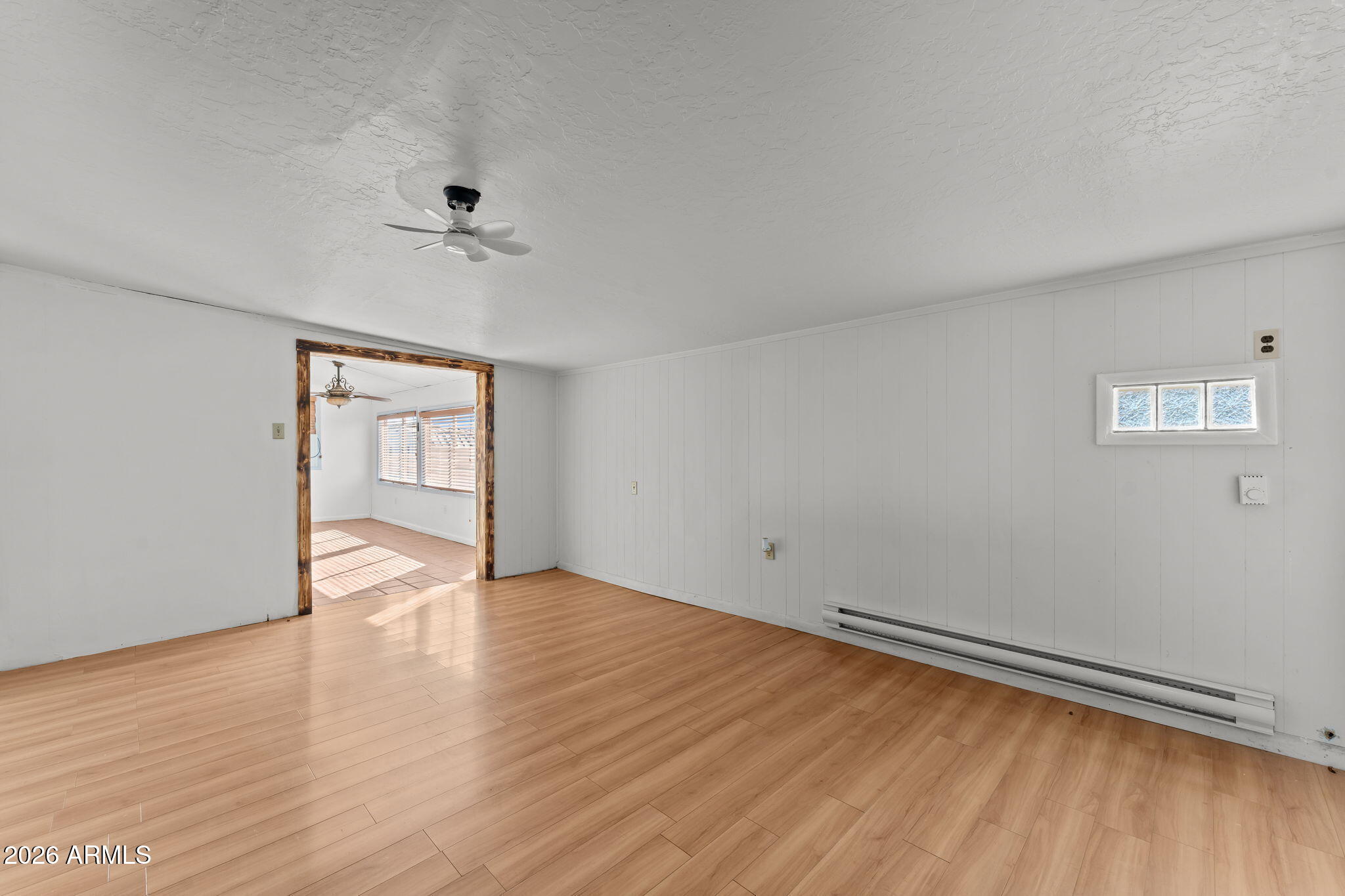 22905 Ranch Road Congress, AZ 85332 - Photo 18 of 26 a view of an empty room with wooden floor and a window