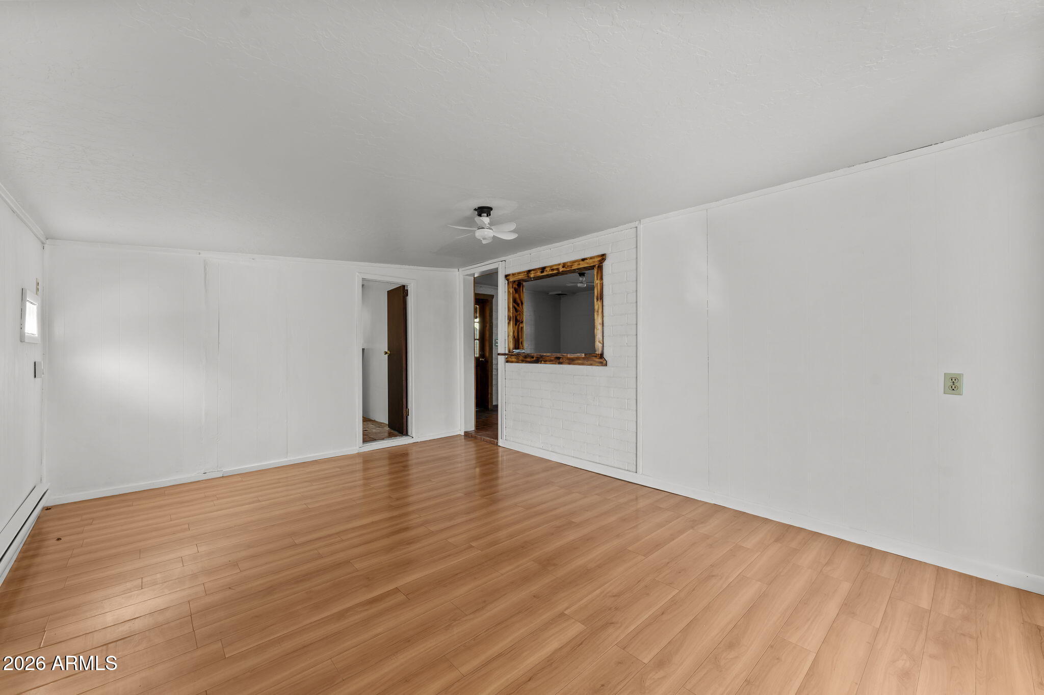 22905 Ranch Road Congress, AZ 85332 - Photo 19 of 26 a view of an empty room with wooden floor