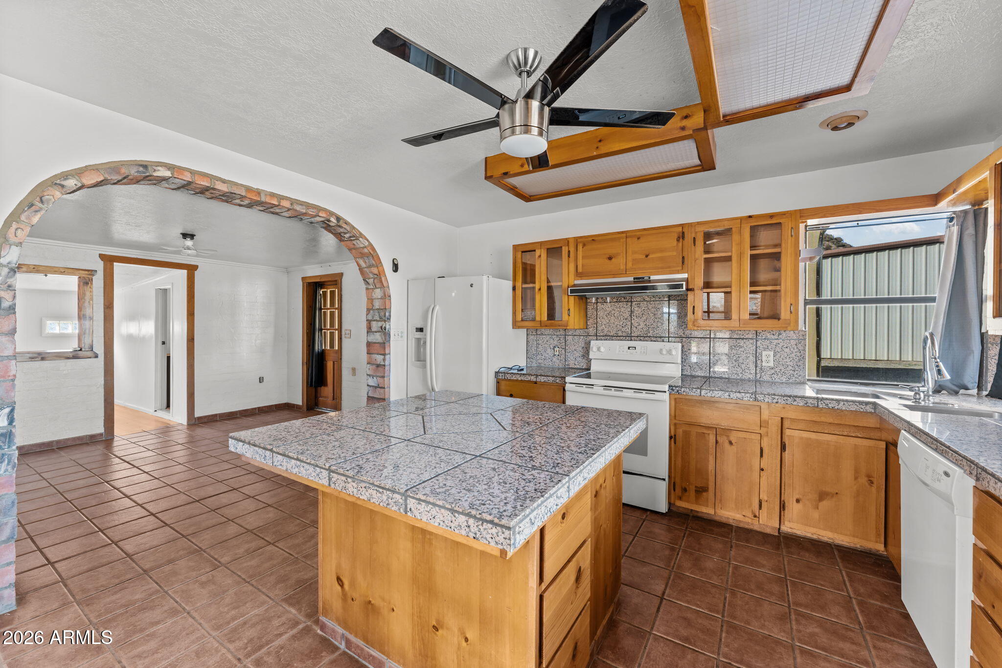 22905 Ranch Road Congress, AZ 85332 - Photo 2 of 26 a kitchen with stainless steel appliances granite countertop a sink and a refrigerator