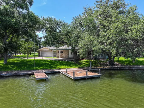 a swimming pool with outdoor seating and lake view