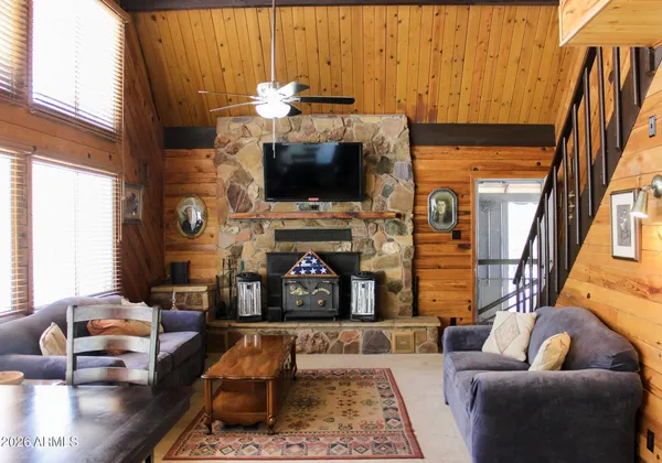 a living room with fireplace furniture and a flat screen tv
