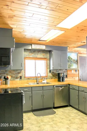 a kitchen with a sink and wooden cabinets