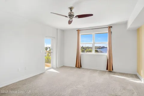 a view of empty room with ceiling fan
