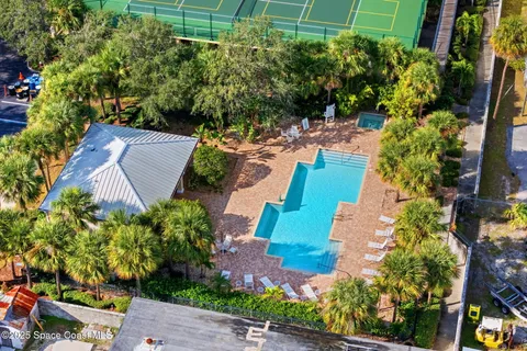 an aerial view of a house with a yard and garden