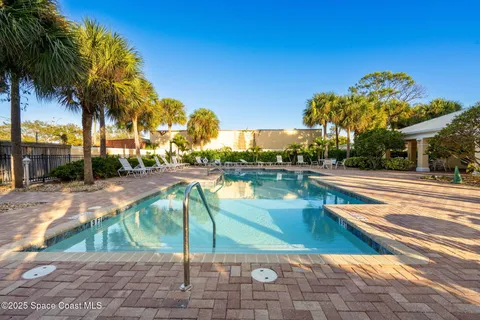 a view of a swimming pool with a lounge chairs