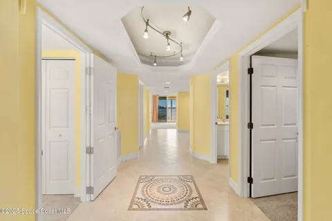 view of a hallway with wooden floor and a livingroom