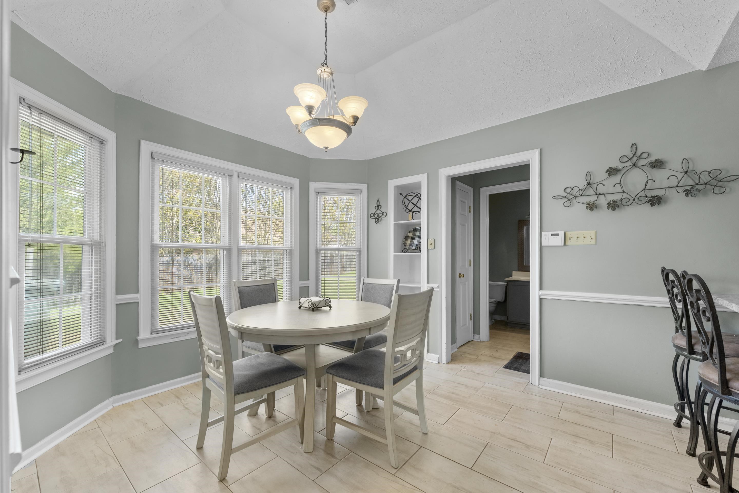 8956 Meadow Ridge Cove East Memphis, TN 38016 - Photo 13 of 28 a view of a dining room with furniture window and outside view