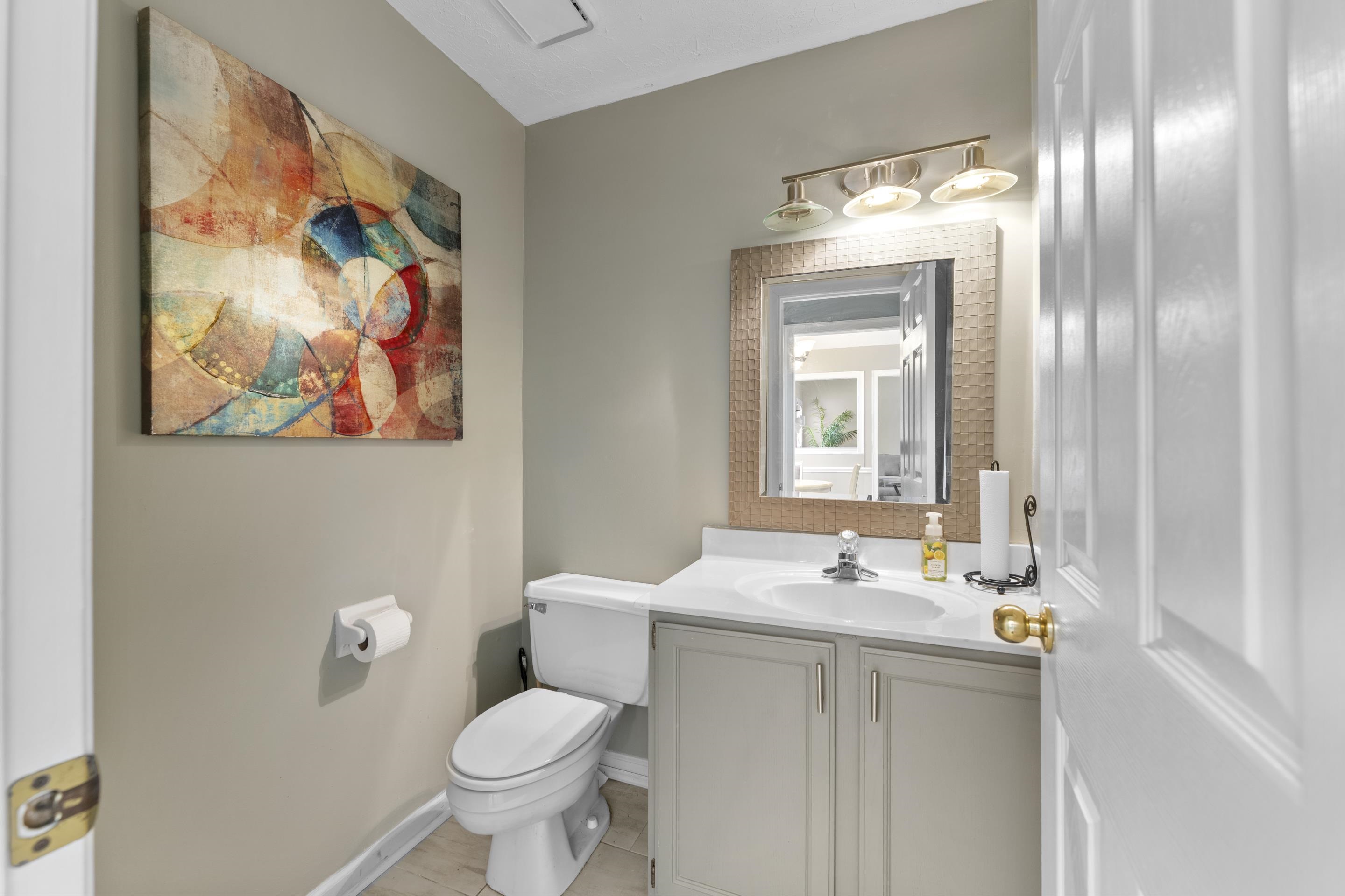 8956 Meadow Ridge Cove East Memphis, TN 38016 - Photo 14 of 28 a bathroom with a toilet sink and mirror