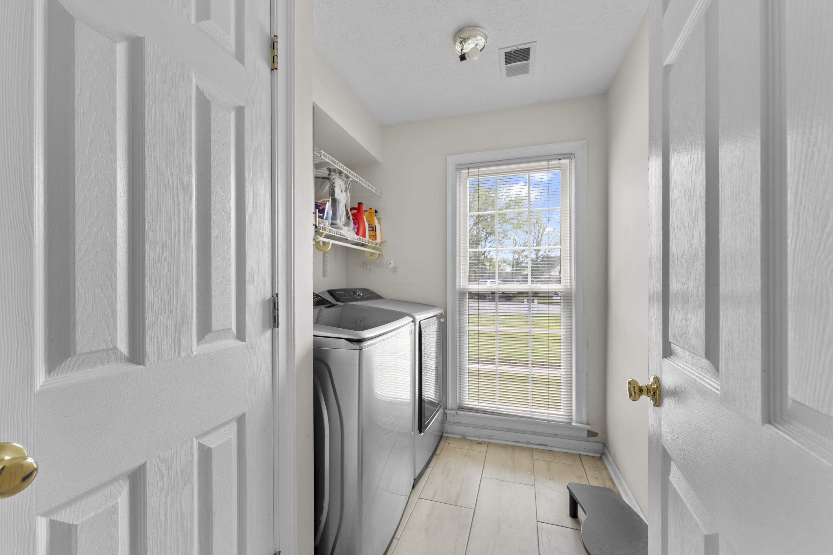 8956 Meadow Ridge Cove East Memphis, TN 38016 - Photo 15 of 28 a kitchen with a refrigerator and window