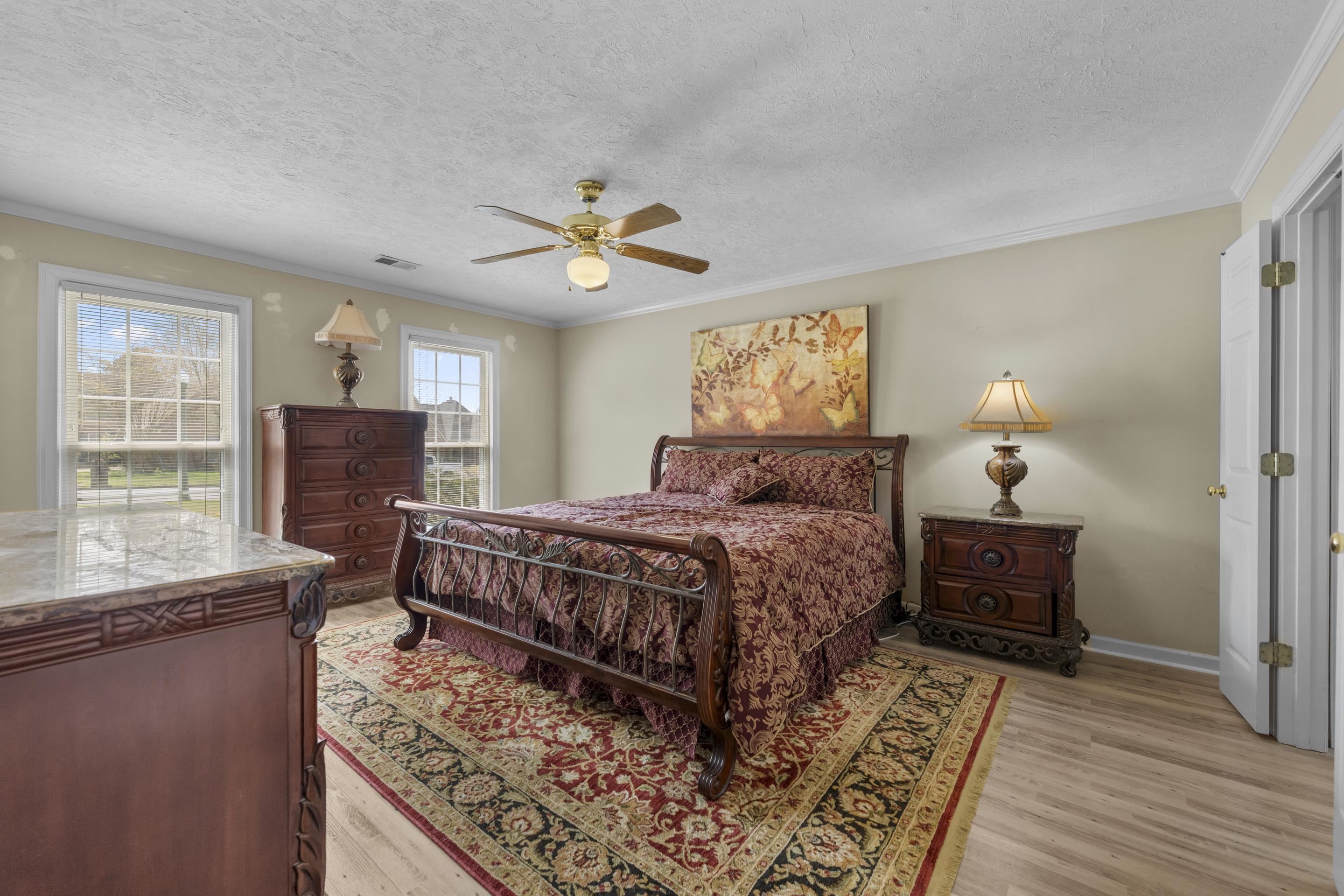 8956 Meadow Ridge Cove East Memphis, TN 38016 - Photo 16 of 28 a bedroom with a bed and wooden floor