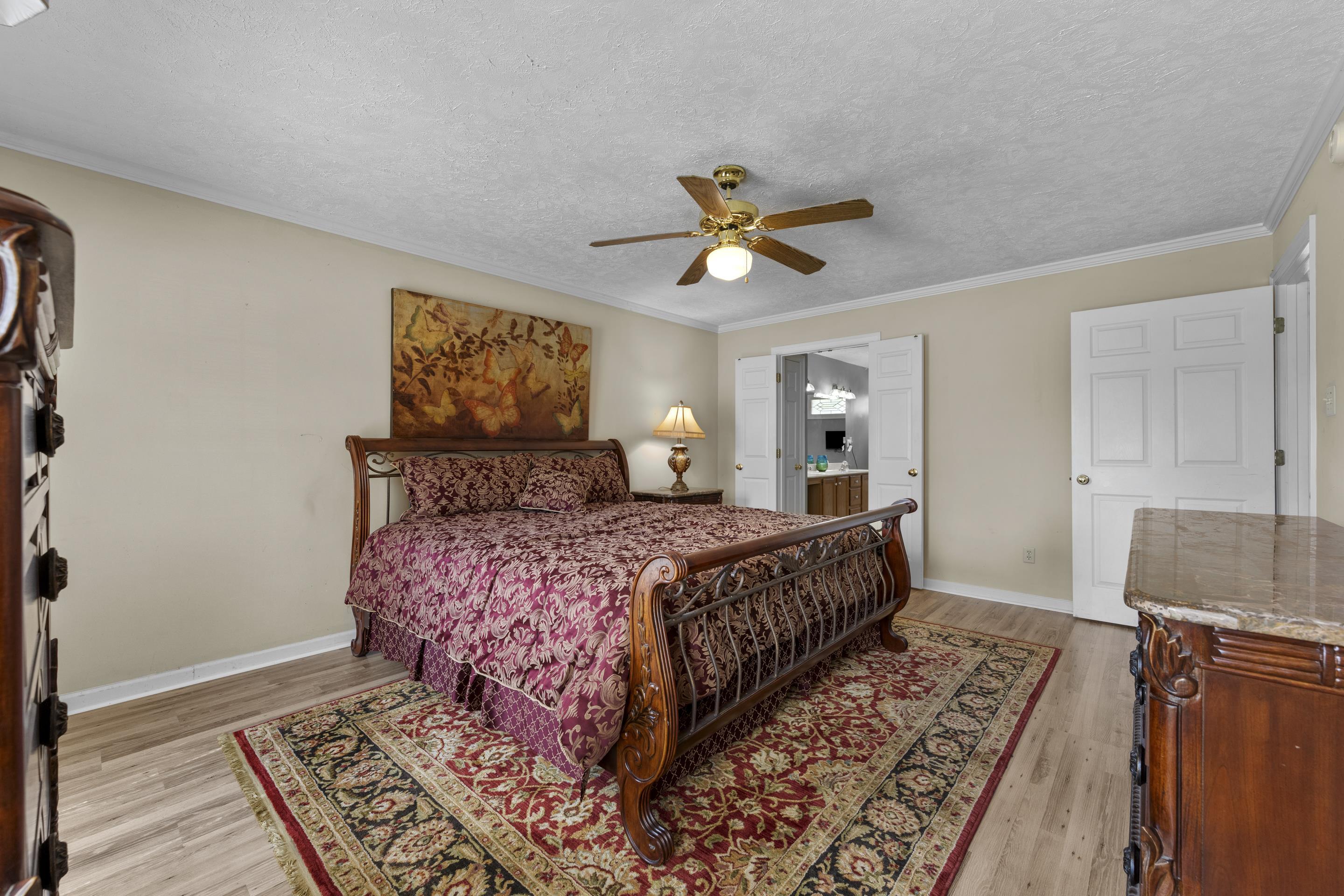 8956 Meadow Ridge Cove East Memphis, TN 38016 - Photo 17 of 28 a bedroom with a large bed and a window