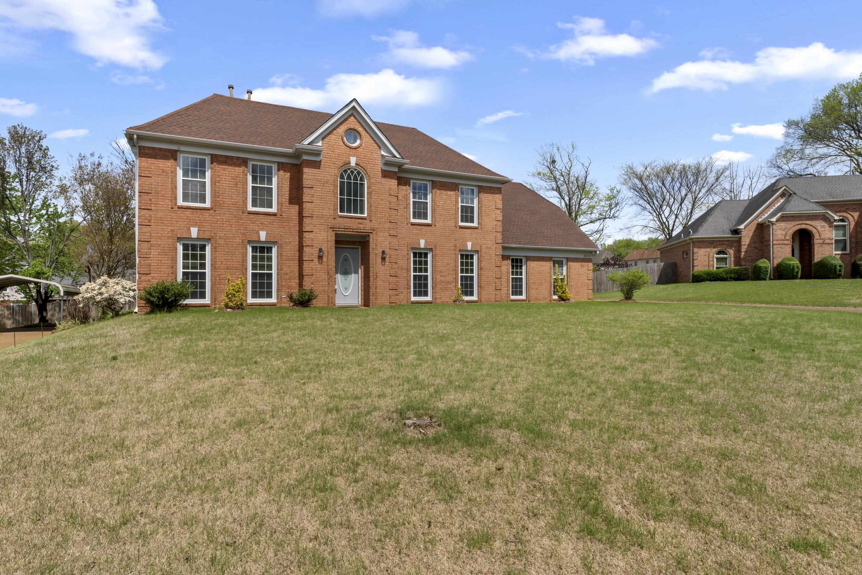 8956 Meadow Ridge Cove East Memphis, TN 38016 - Photo 2 of 28 a front view of a house with a yard