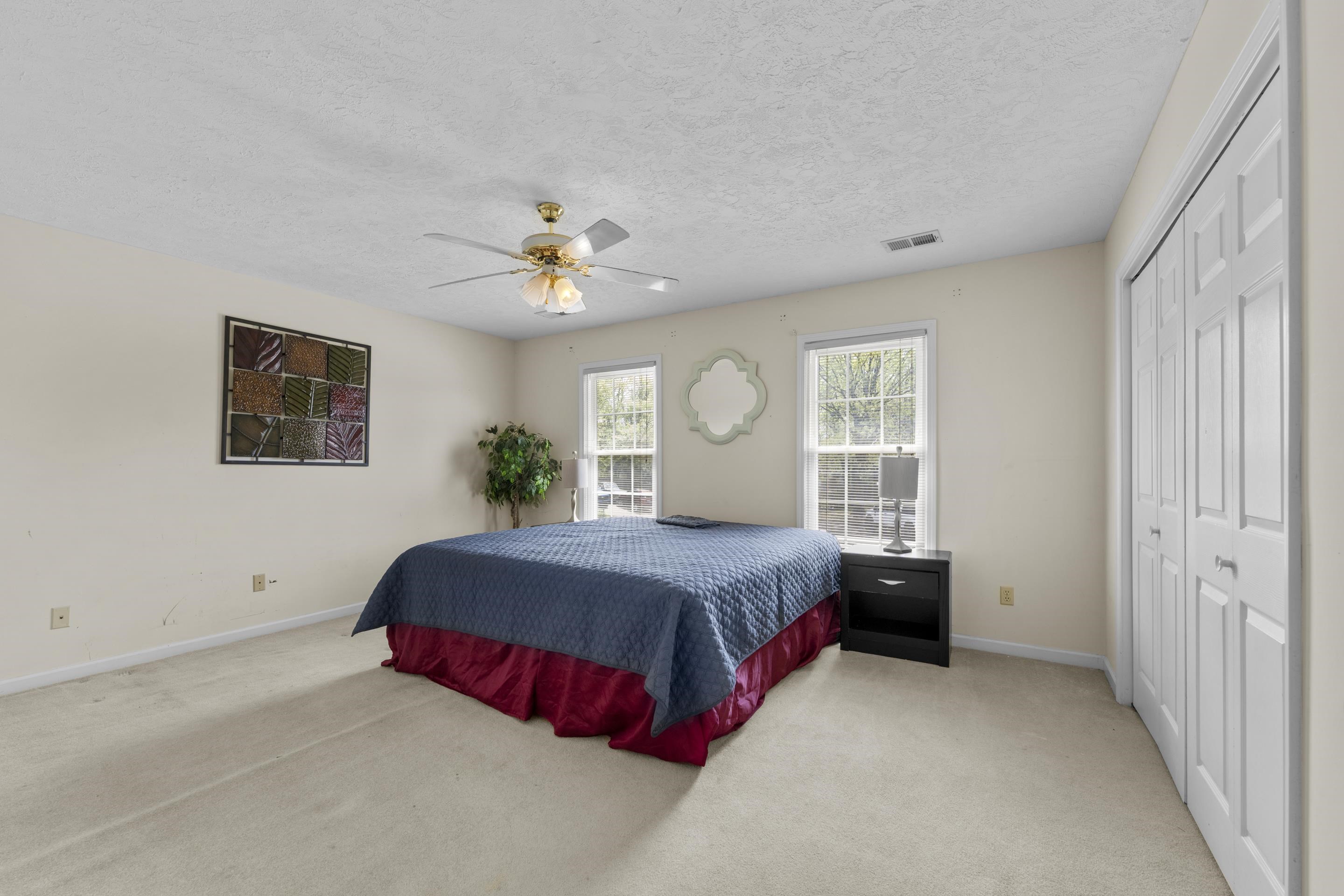 8956 Meadow Ridge Cove East Memphis, TN 38016 - Photo 21 of 28 a spacious bedroom with a bed and a window