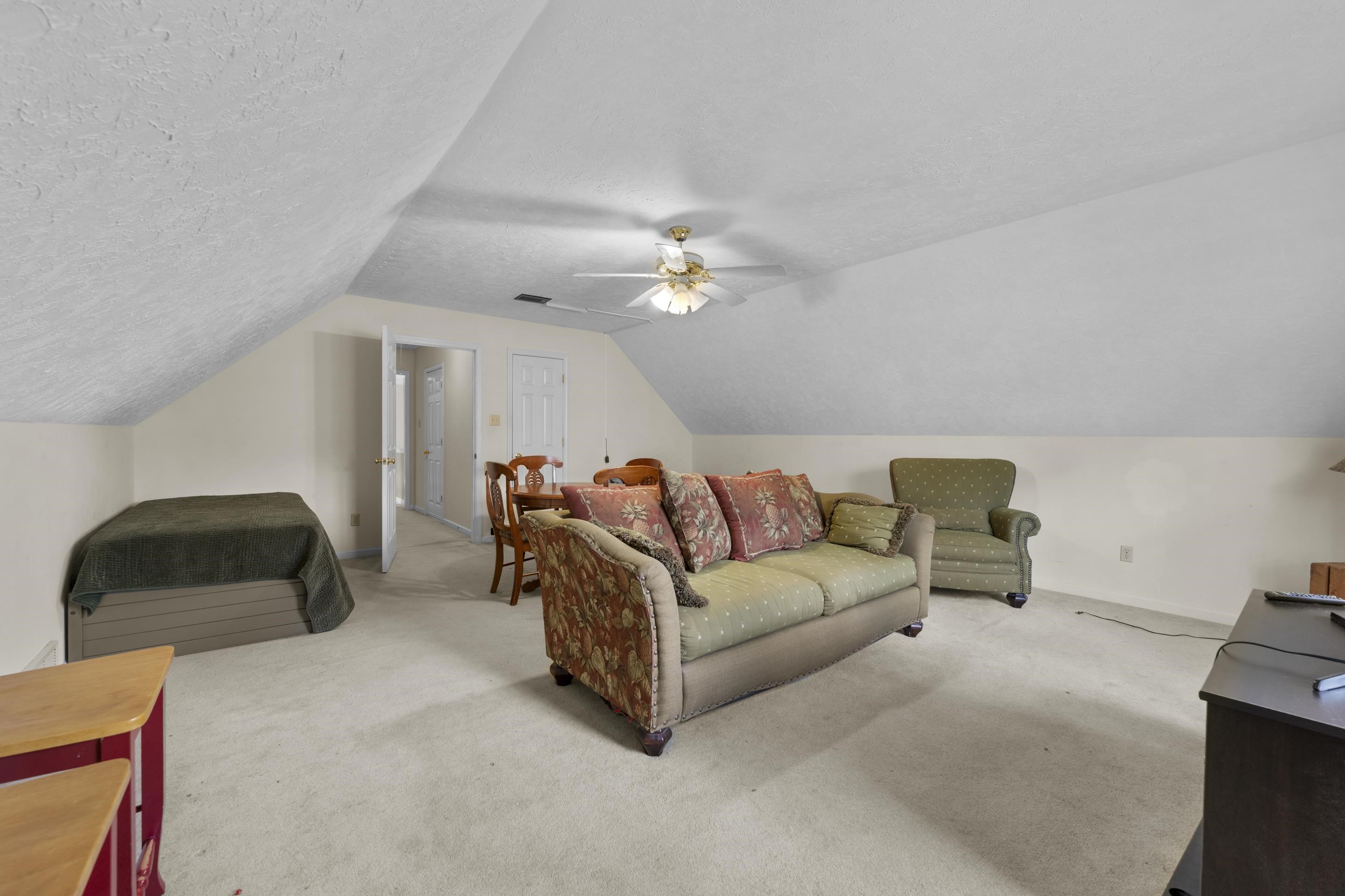 8956 Meadow Ridge Cove East Memphis, TN 38016 - Photo 24 of 28 a living room with furniture and a chandelier