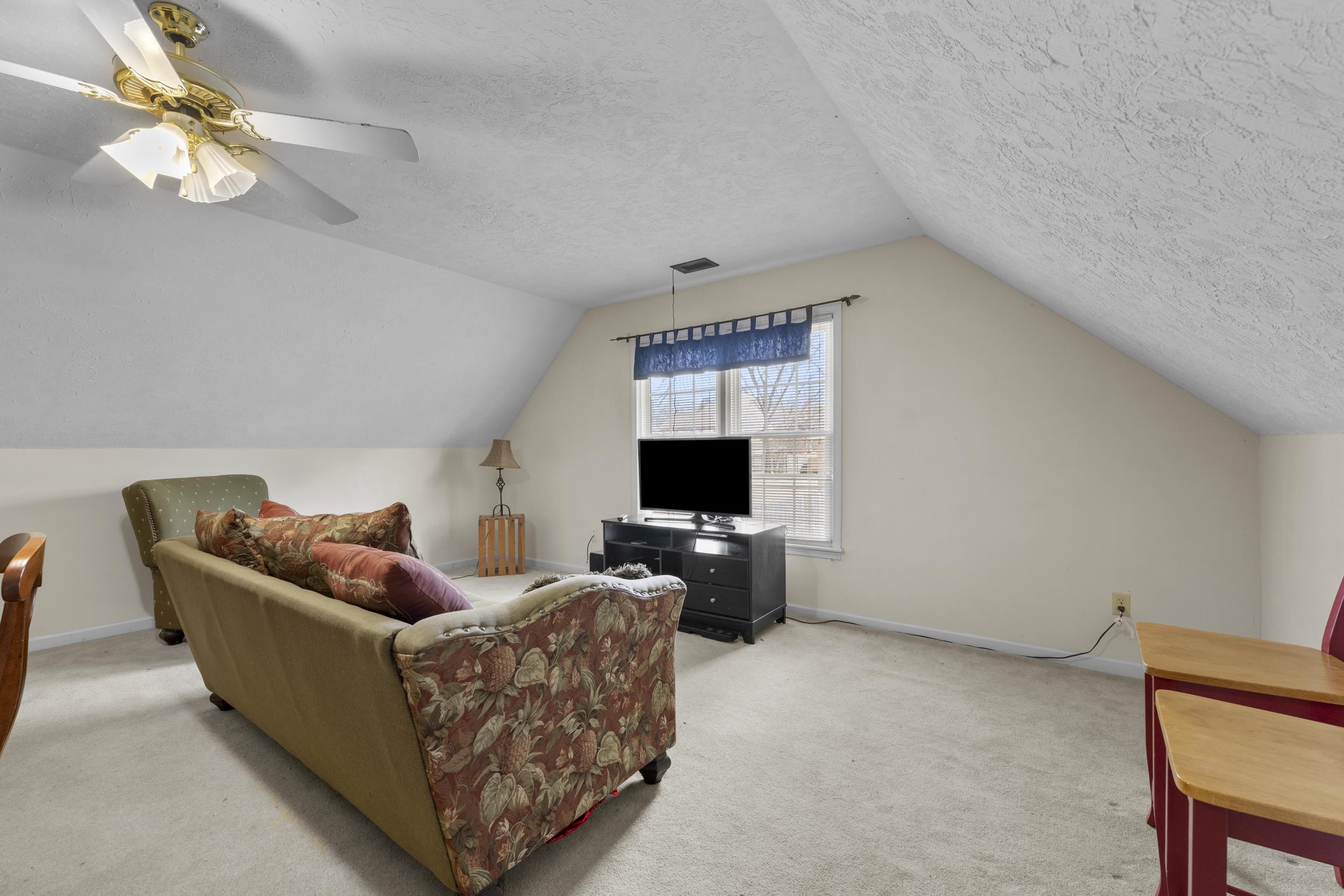 8956 Meadow Ridge Cove East Memphis, TN 38016 - Photo 25 of 28 a living room with furniture and a flat screen tv